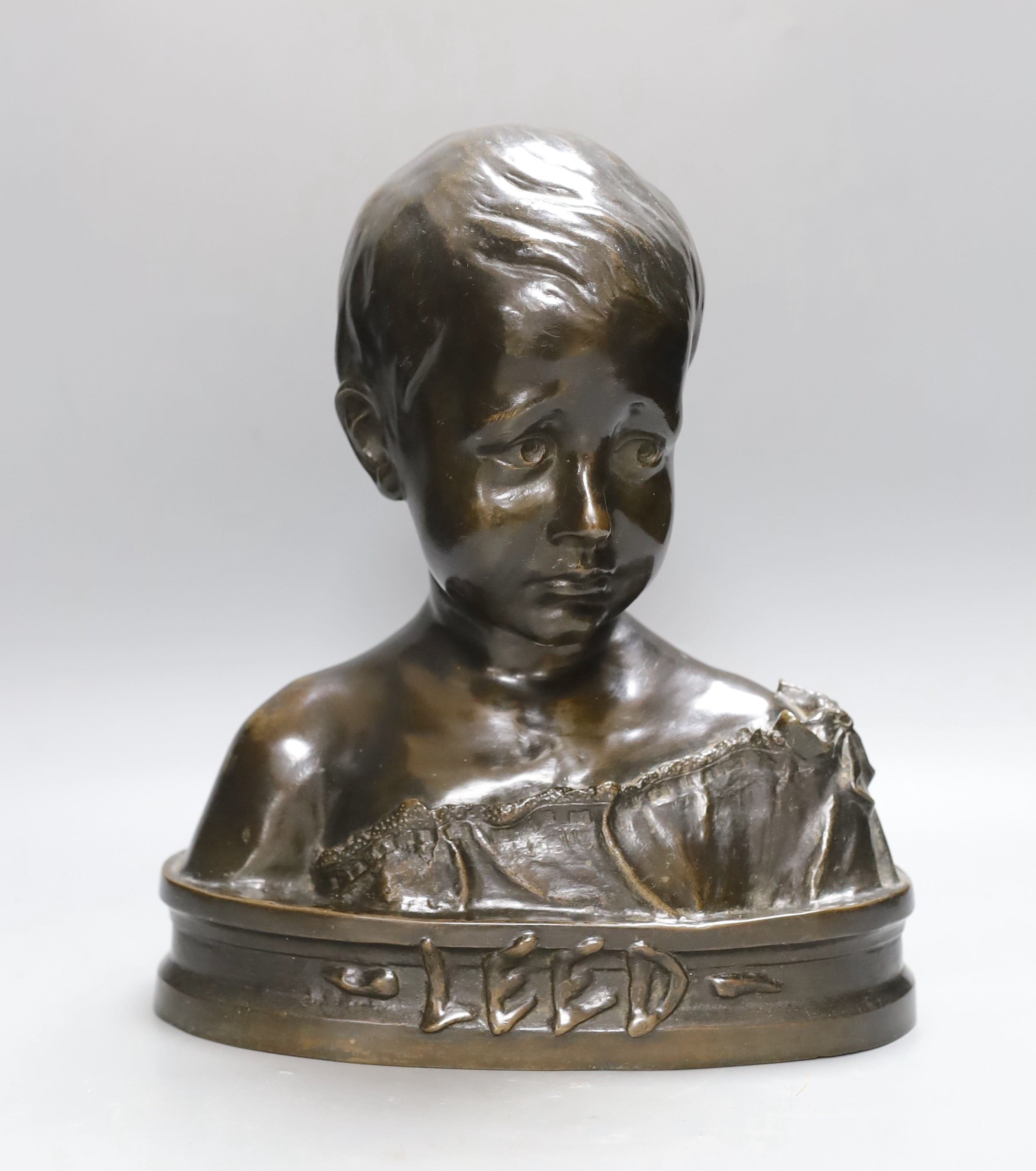 A bronze bust of a boy entitled ‘Leed’, 31cm high